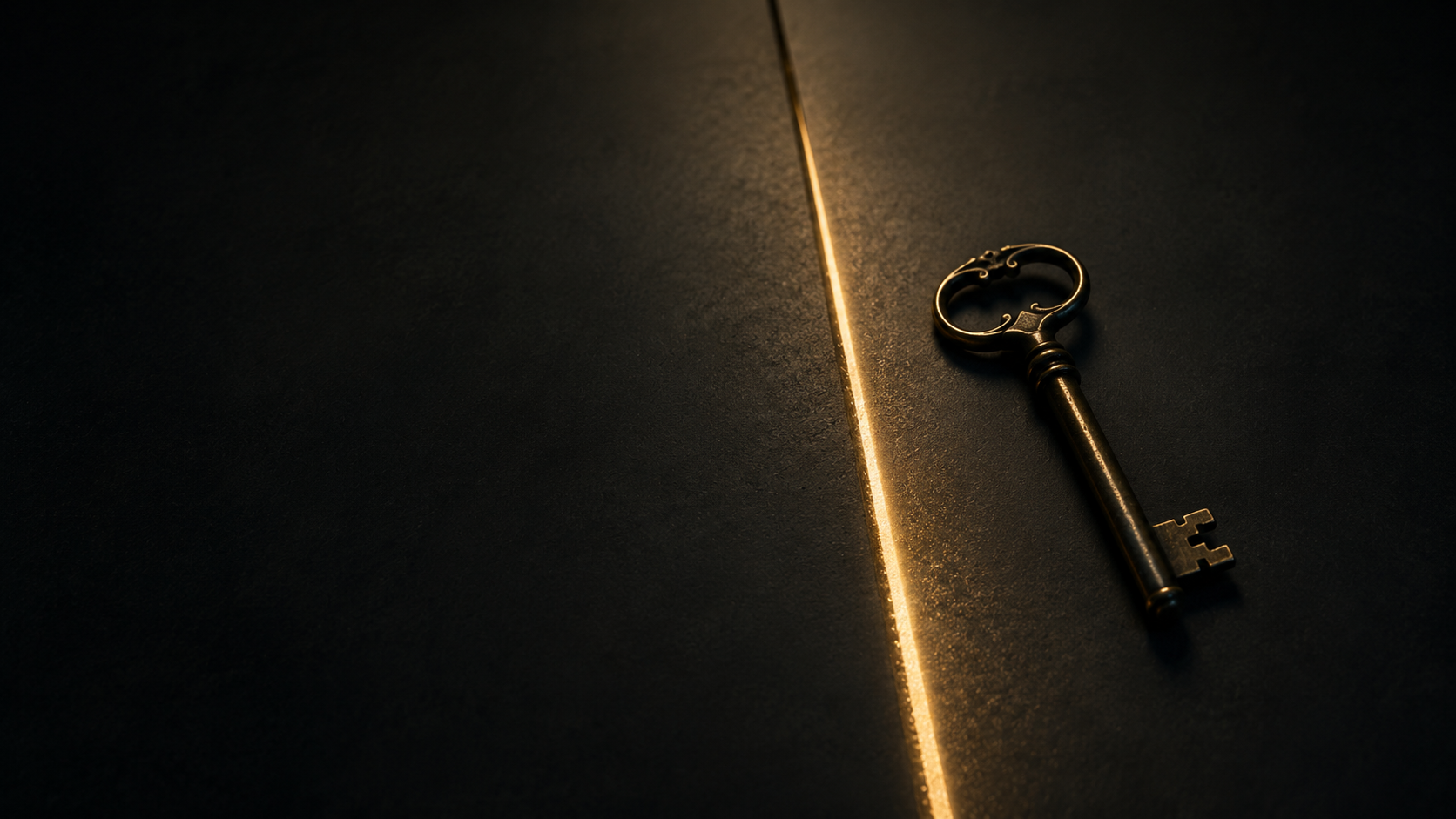 An antique key beside a narrow line of gold light.